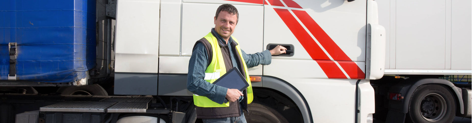 man standing beside a truck